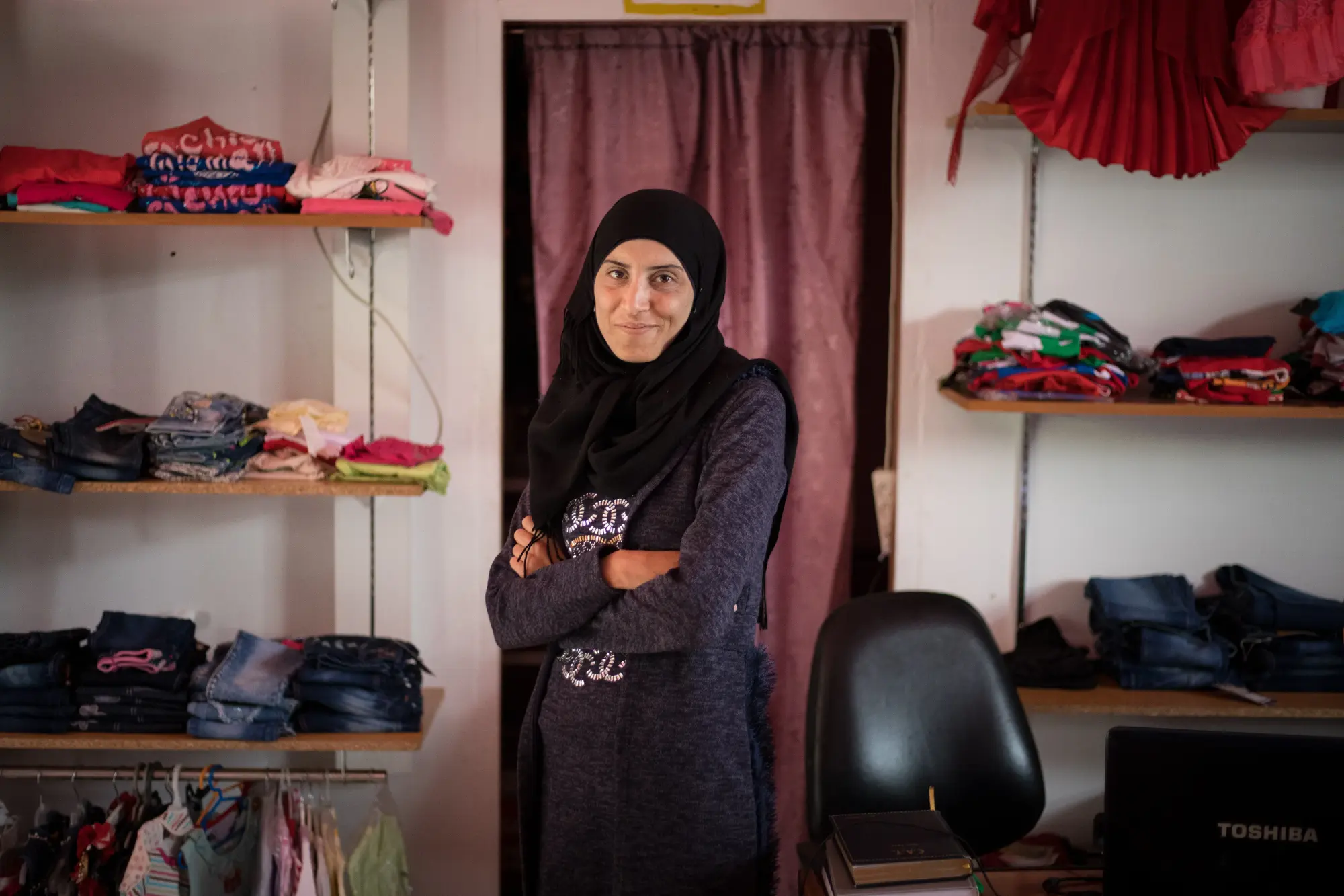 Nour, a Syrian refugee in Lebanon, took a loan funded by Kiva lenders to buy clothes to go into business with her boss and stock their store.
