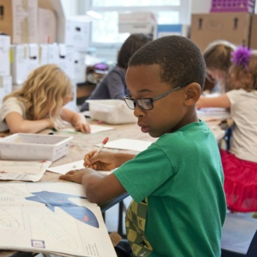 Picture of a child in a classroom from unsplash